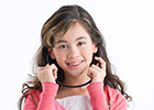 A tween protecting her ears with earplugs